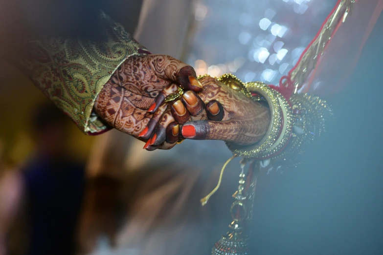 a close up of a person holding a cell phone, by Gwen Barnard, pexels contest winner, hurufiyya, hindu ornaments, holding hands, wedding, thumbnail