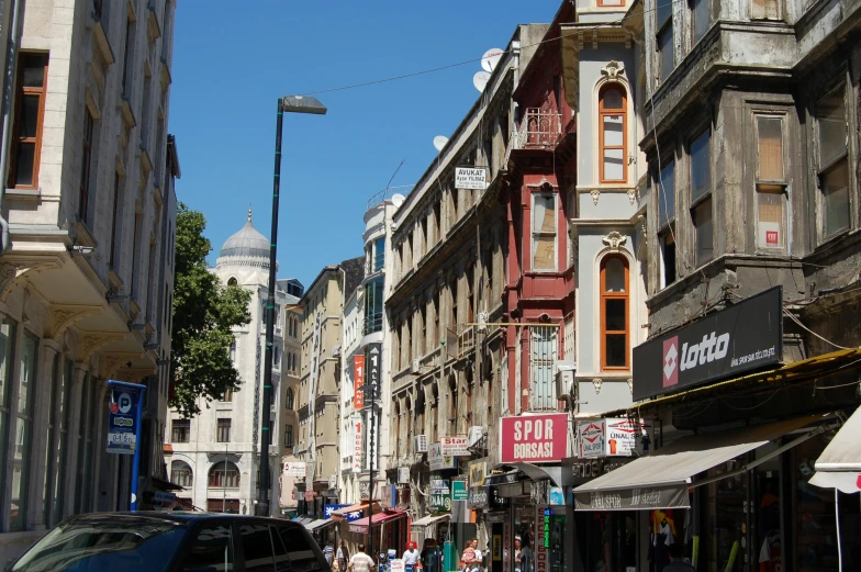 a group of people walking down a street next to tall buildings, art nouveau, baris yesilbas, house's and shops and buildings, profile image