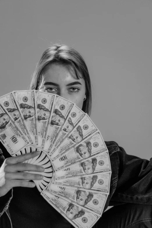 a woman holding a fan of money in front of her face, a black and white photo, pexels contest winner, hyperrealism, mrbeast, dua lipa, jill stingray, ansel ]