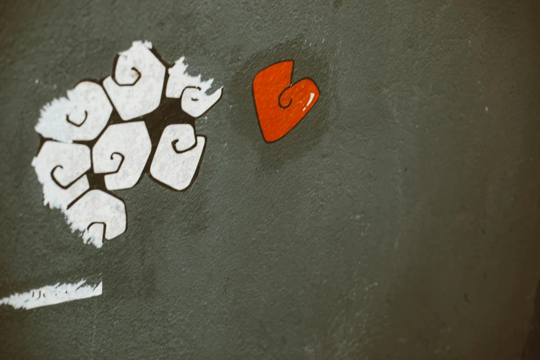 a piece of art that is on the side of a wall, unsplash, graffiti, hearts symbol, grey orange, background image, red nose