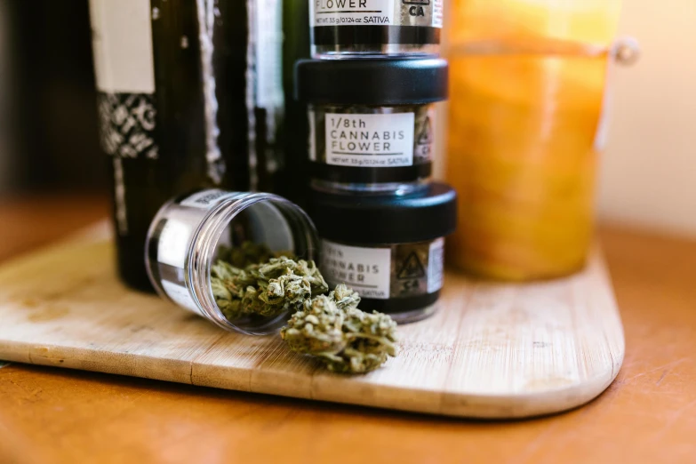 a pile of marijuana sitting on top of a cutting board, a portrait, by Julia Pishtar, unsplash, jars, skincare, recipe, flower power