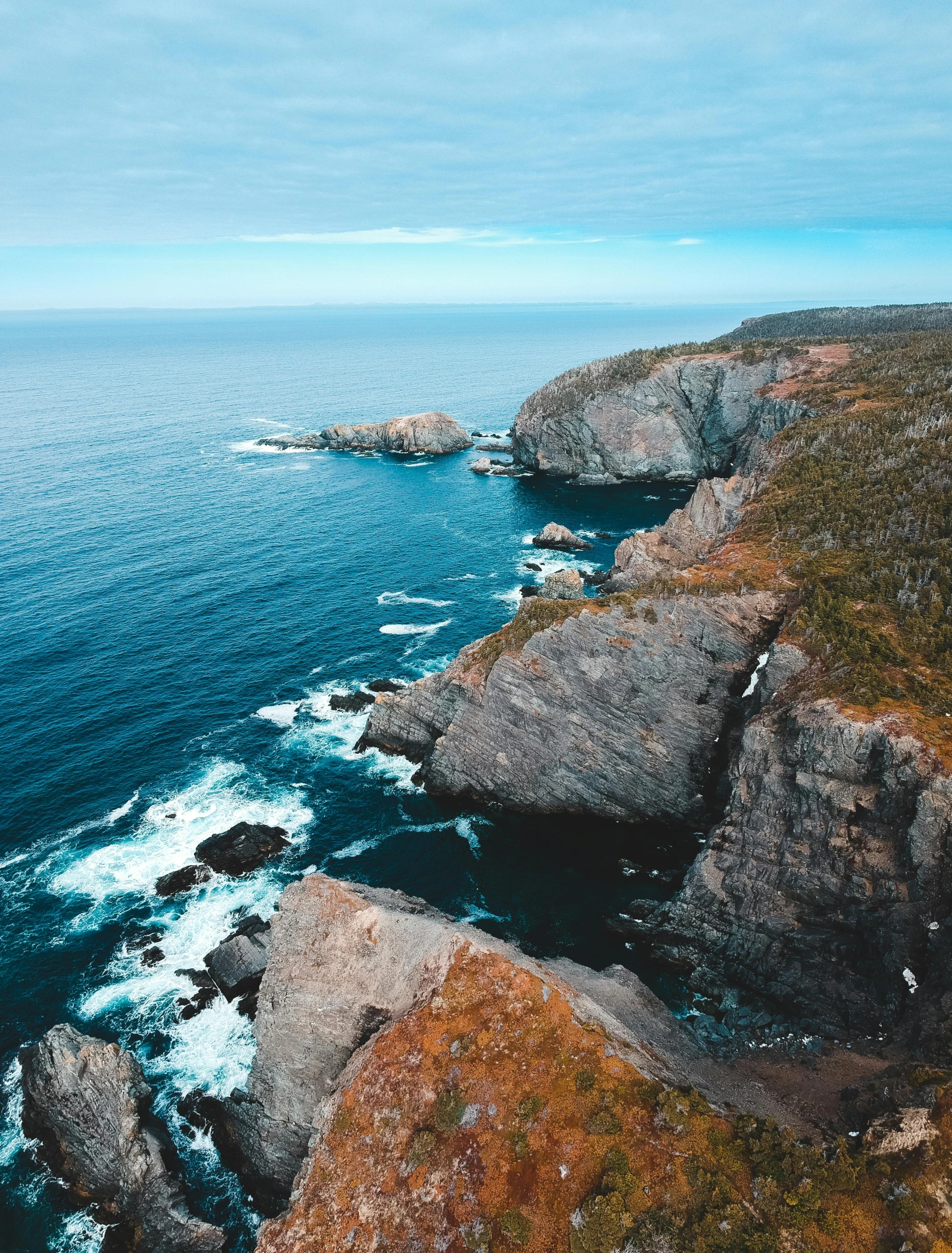 a view of the ocean from the top of a cliff, by Terese Nielsen, pexels contest winner, sharp cliffs, victoria siemer, big rocks, thumbnail