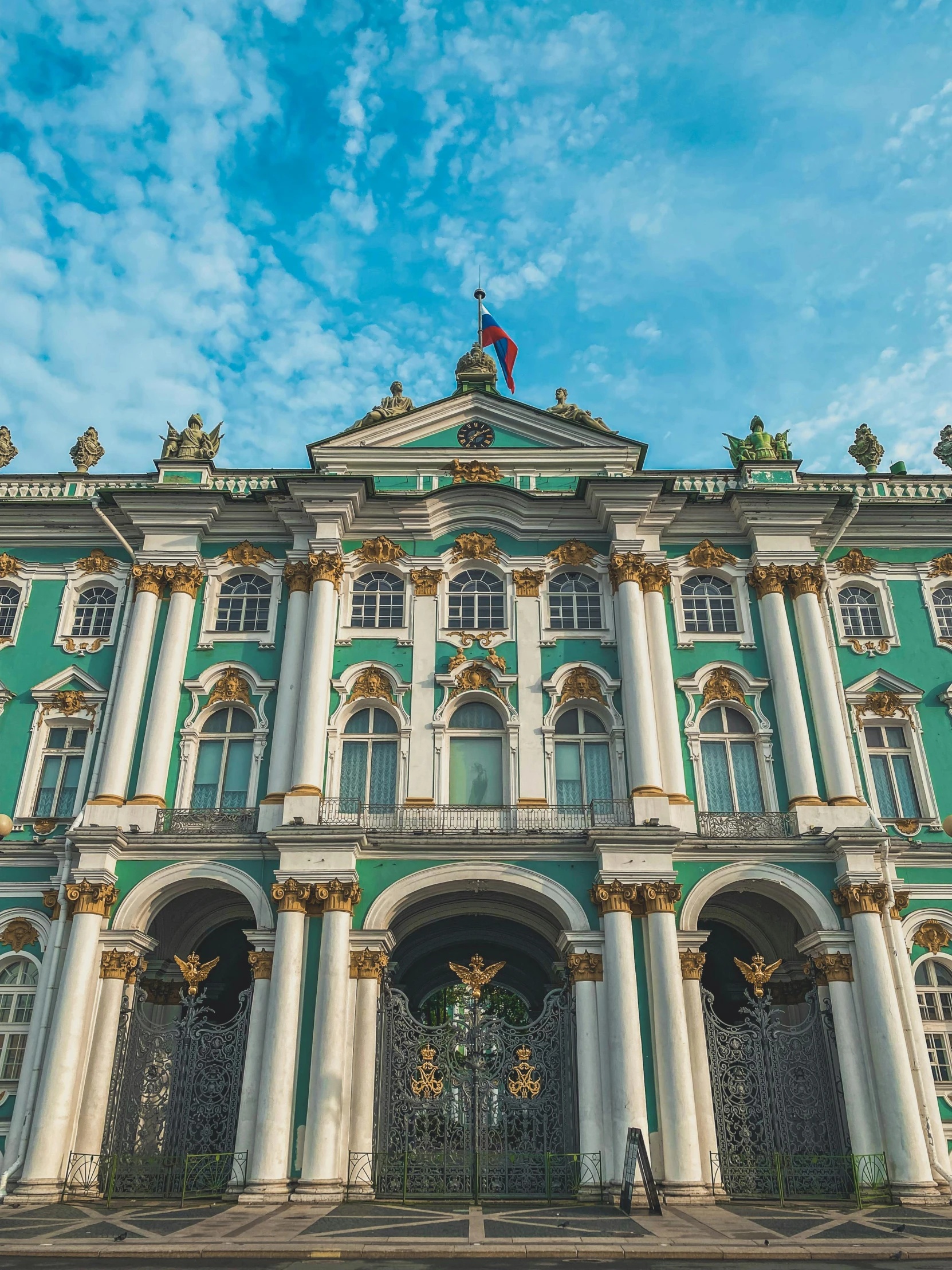 a green and white building with a blue sky in the background, inspired by Vasily Surikov, neoclassicism, square, profile image, festival of rich colors, russia in 2 0 2 1