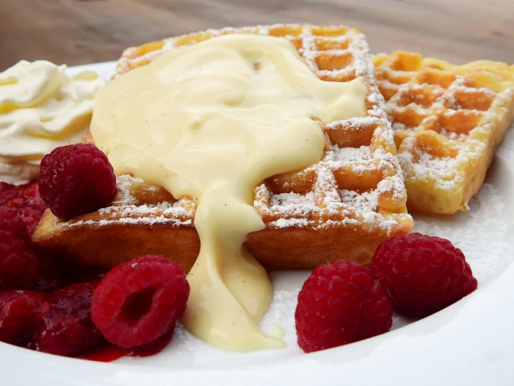 a white plate topped with waffles and raspberries, pexels contest winner, hurufiyya, cream, molten, blender, yellow