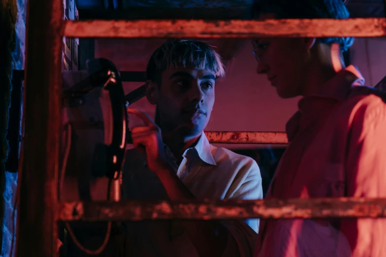 a couple of men standing next to each other, by Elsa Bleda, pexels contest winner, serial art, cinematic neon uplighting, declan mckenna, still from the movie saw, petra collins and mc. escher