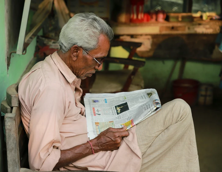 a man sitting on a bench reading a newspaper, a portrait, pexels contest winner, private press, kerala village, portrait of an old, 15081959 21121991 01012000 4k, thumbnail