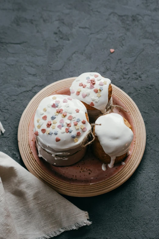 a plate of donuts with frosting and sprinkles, a still life, by Jan Tengnagel, unsplash, renaissance, several hearts, on a wooden plate, steamed buns, covered in white flour