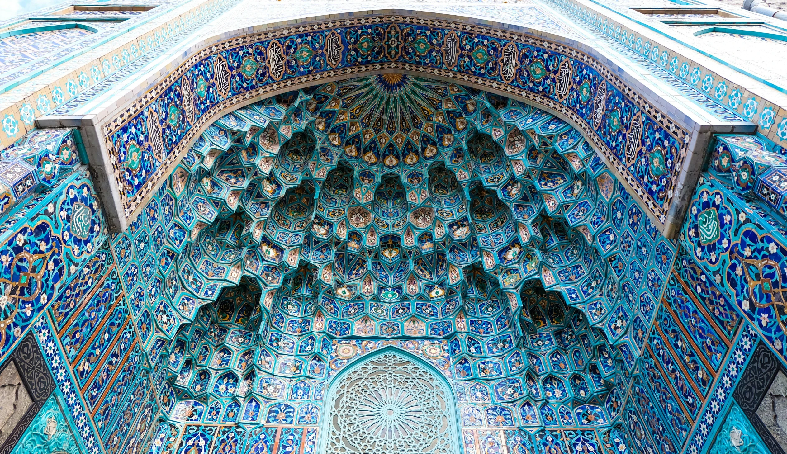 a close up of the inside of a building, a mosaic, pexels contest winner, arabesque, turquoise color scheme, massive arch, decorated with russian motifs, islamic calligraphy