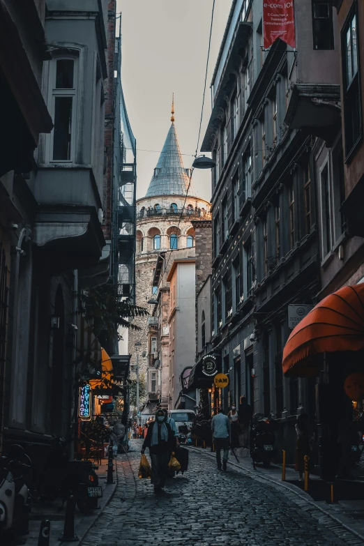 a narrow cobblestone street with a clock tower in the background, pexels contest winner, art nouveau, ottoman sultan, crowded city, gif, neoclassical tower with dome