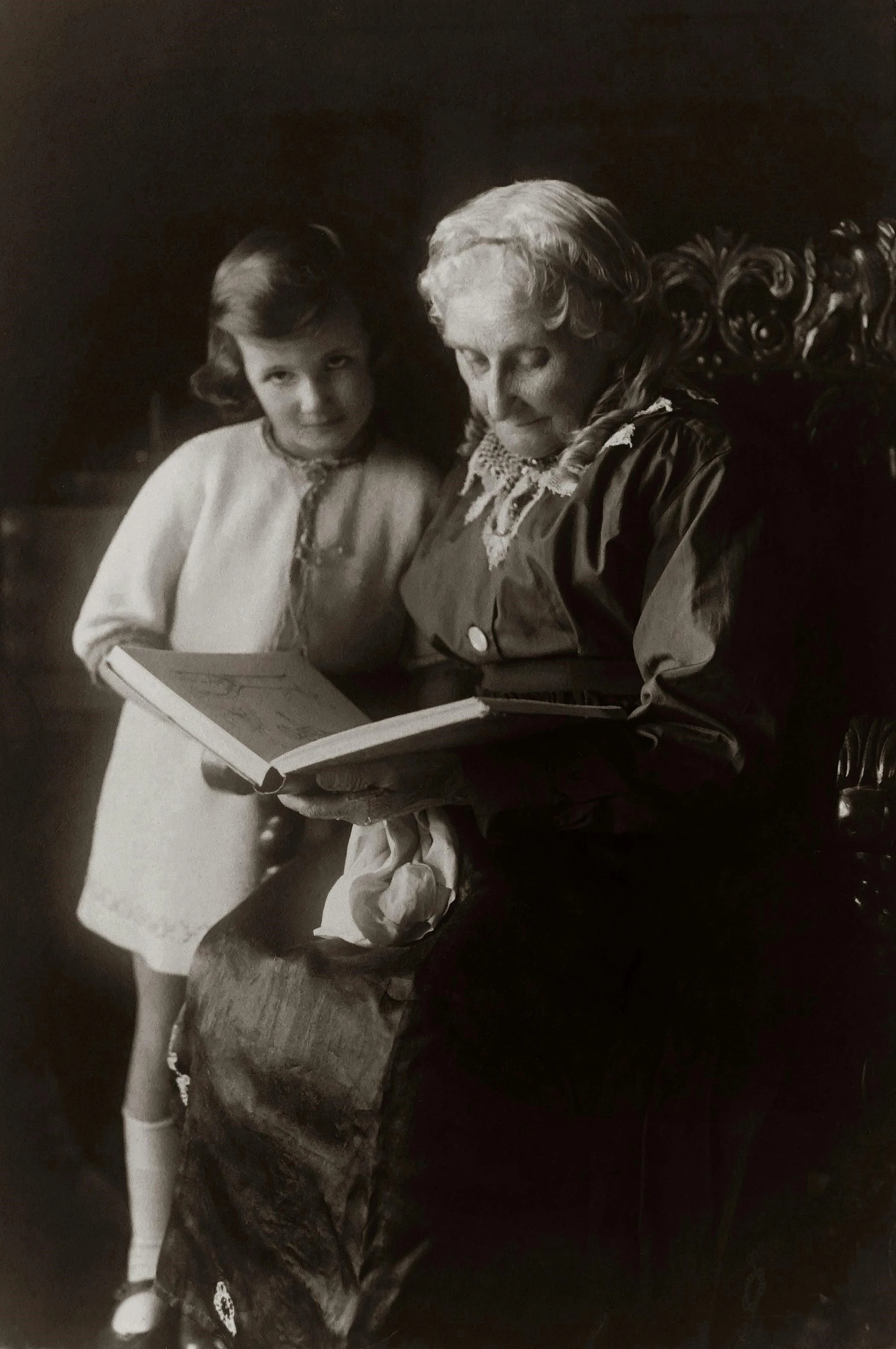 an old black and white photo of a woman and a little girl, pexels, arts and crafts movement, reading a book, albert einstein, old man, color image