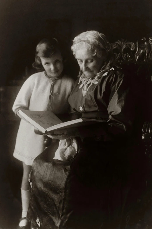an old black and white photo of a woman and a little girl, pexels, arts and crafts movement, reading a book, albert einstein, old man, color image