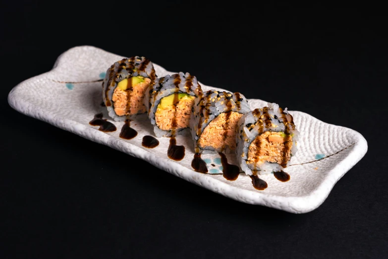 a close up of a plate of food on a table, sushi, detailed product image, front facing shot, caramel