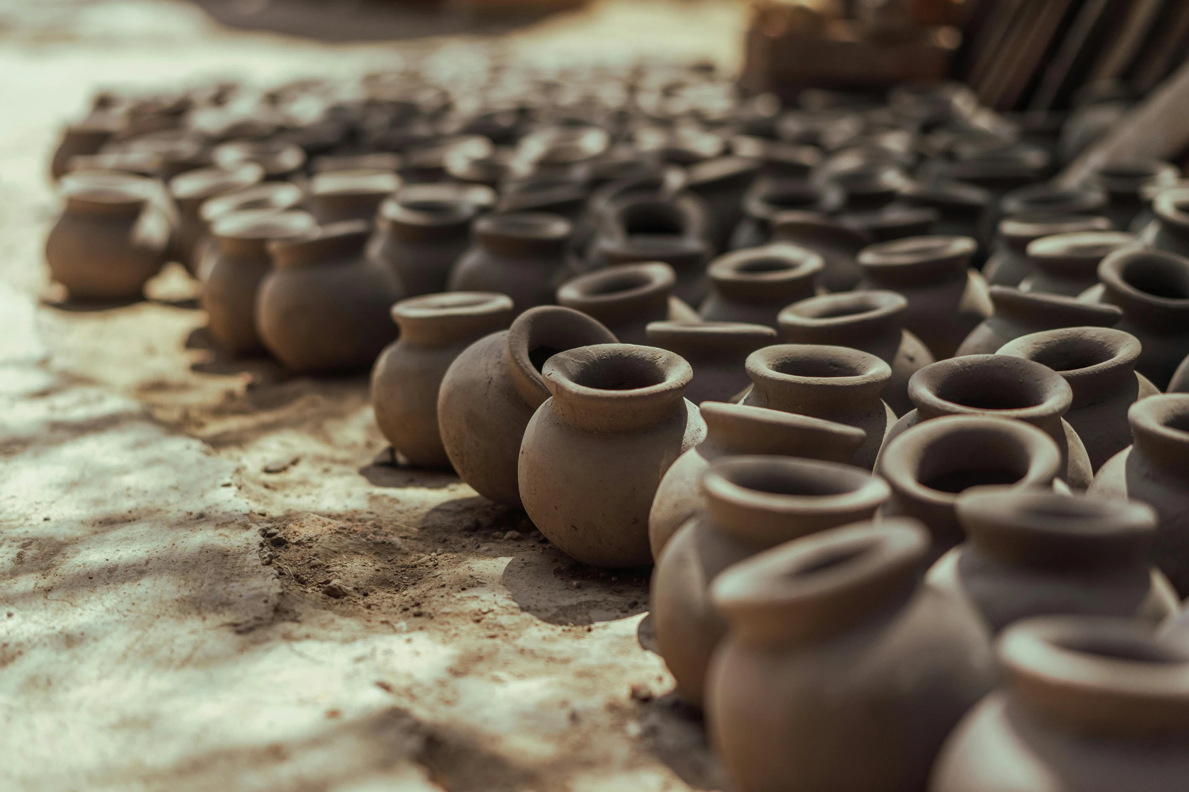 a group of clay pots sitting on top of a table, trending on unsplash, shipibo, villages ， unreal engine, alessio albi, museum photo