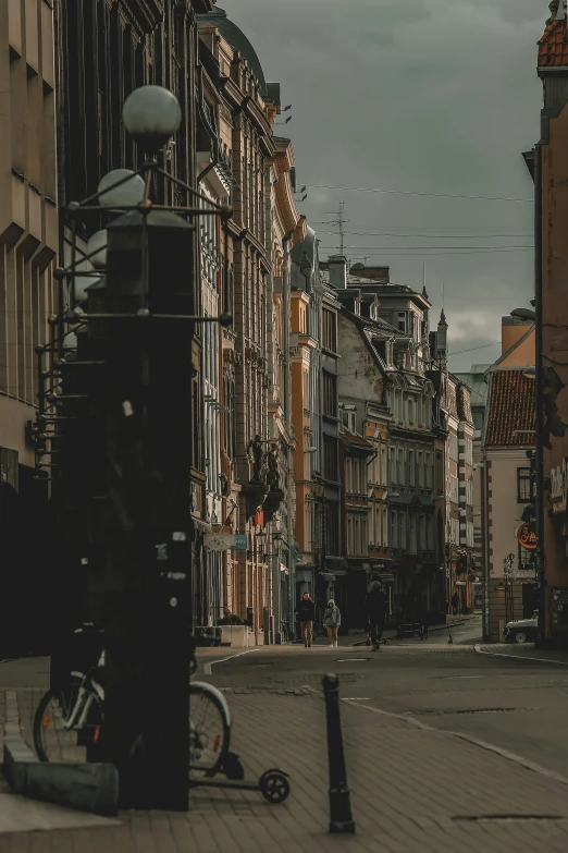 a city street filled with lots of tall buildings, a photo, pexels contest winner, baroque, shady alleys, lampposts, poland, gif