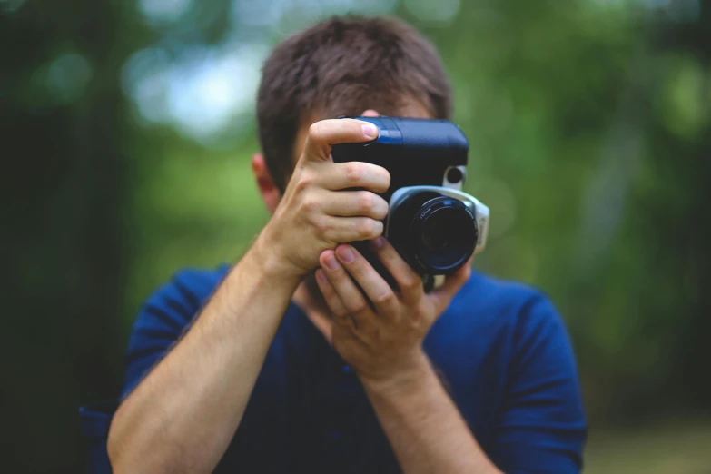 a man taking a picture with a camera, colour photograph, zoomed out photography, promotional photography, cute photograph