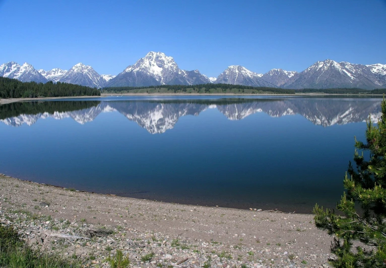 a body of water with mountains in the background, by Ethel Schwabacher, pexels contest winner, land art, clear sunny day, broadway, hall of mirrors, usa-sep 20