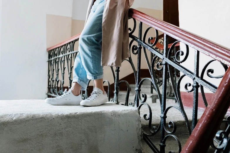 a woman standing on a set of stairs talking on a cell phone, a picture, by Maud Naftel, pexels contest winner, happening, wearing white sneakers, white soft leather model, background image, decoration