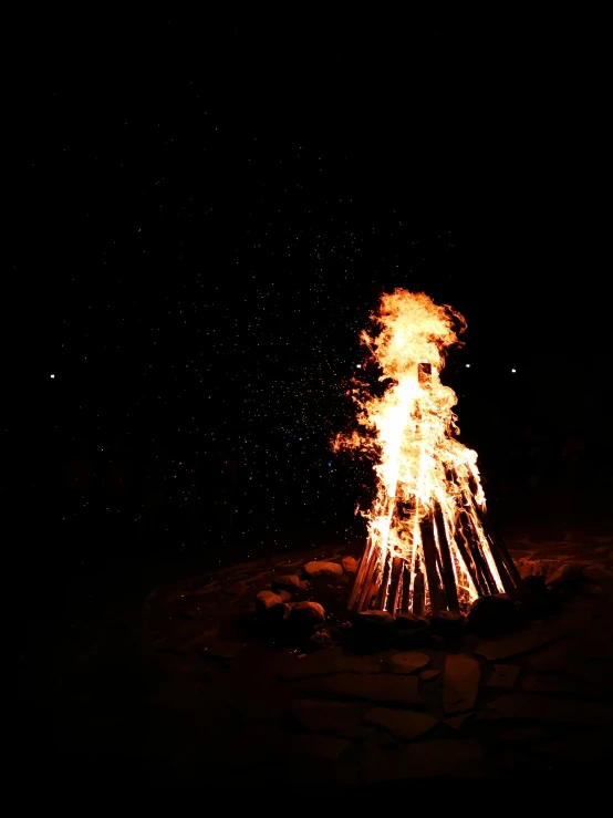 a bonfire is lit up in the dark, taken on a 2010s camera, fan favorite, the fire king, low quality photo