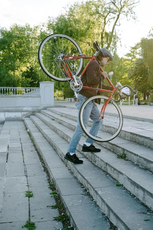 a man carrying a bike up the side of a flight of stairs, pexels contest winner, music video, h3h3, in a city park, soviet - era