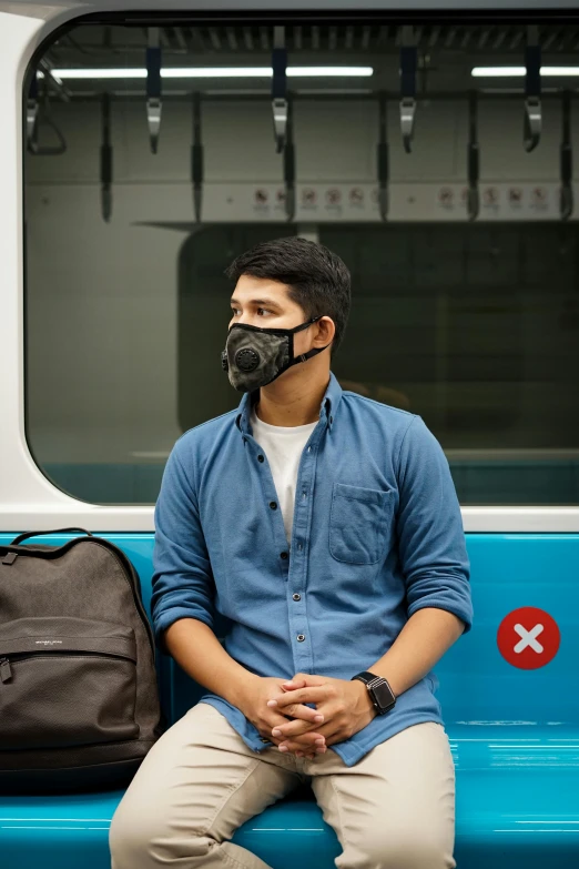 a man wearing a face mask sitting on a bus, a picture, “hyper realistic, respirator, ramil sunga, no - text no - logo