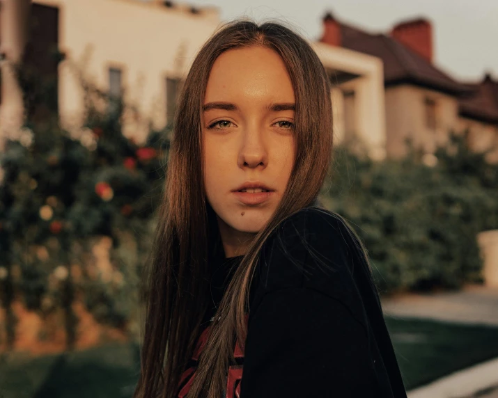 a woman with long hair standing in front of a house, pexels contest winner, realism, portrait of normal teenage girl, perfectly lit face, looks a blend of grimes, maxim sukharev