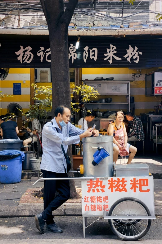 a man pushing a cart of food down a street, an album cover, by Liang Kai, pexels contest winner, cooking oil, subtitles, square, 千 葉 雄 大