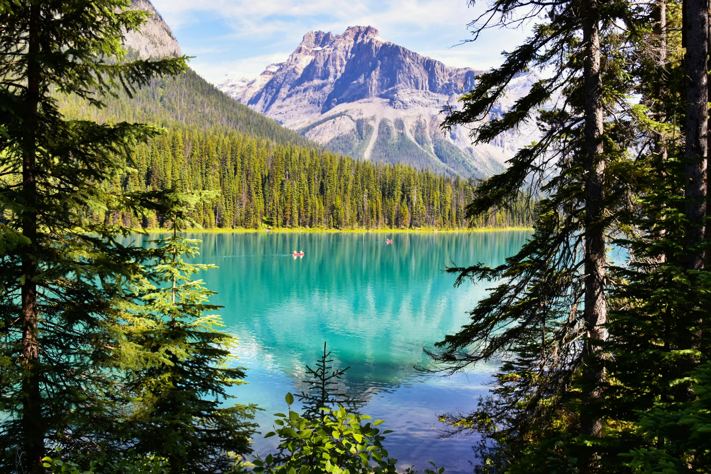 a lake surrounded by trees with a mountain in the background, a photo, canada, turquoise water, conde nast traveler photo