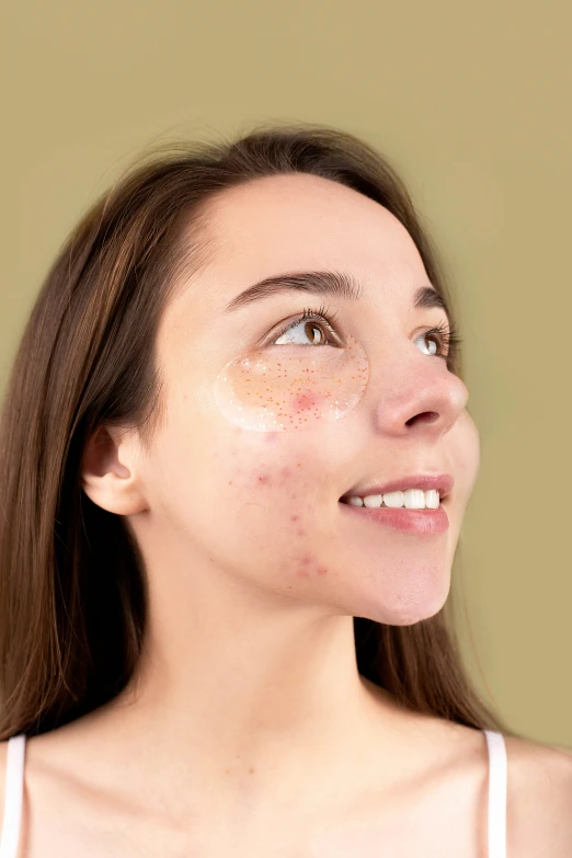 a woman holding a banana in front of her face, trending on pexels, trypophobia acne face, beauty mark on cheek, gold, digitally enhanced