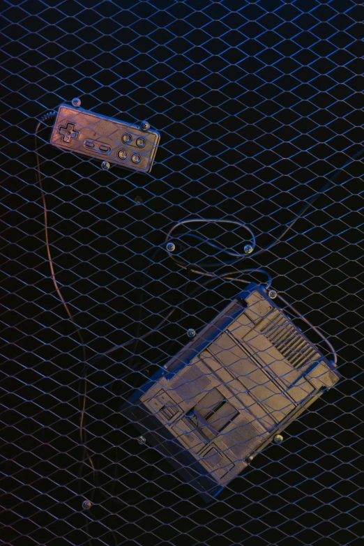 a couple of electronic devices sitting on top of a table, an album cover, by Robert Feke, attached to wires. dark, netting, game top down view, taken in the night