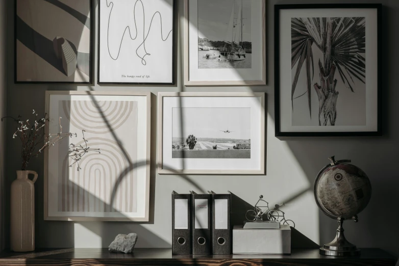 a bunch of pictures hanging on a wall in a room, inspired by Max Dupain, unsplash contest winner, light and space, organic lines, sun dappled, home office interior, framed in image