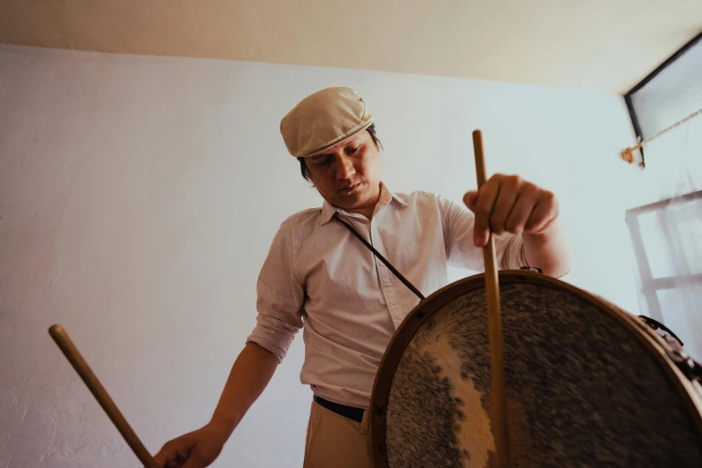 a man that is standing next to a drum, pexels contest winner, renaissance, valentin serov style, press shot, profile image, ready to eat