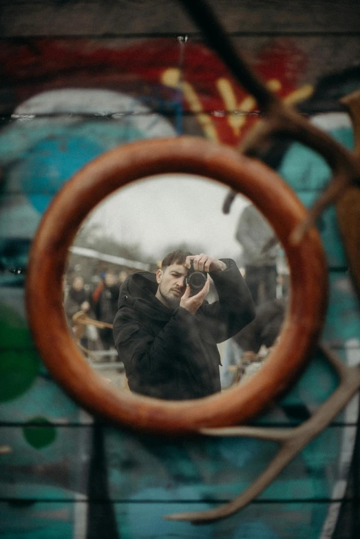 a man taking a picture of himself in a mirror, pexels contest winner, visual art, looking at porthole window, kreuzberg, pointing at the camera, julian ope