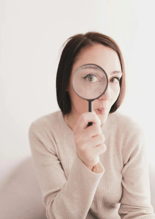 a woman looking through a magnifying glass, trending on pexels, neutral focused gaze, instagram post, inspect in inventory image, wide eyed