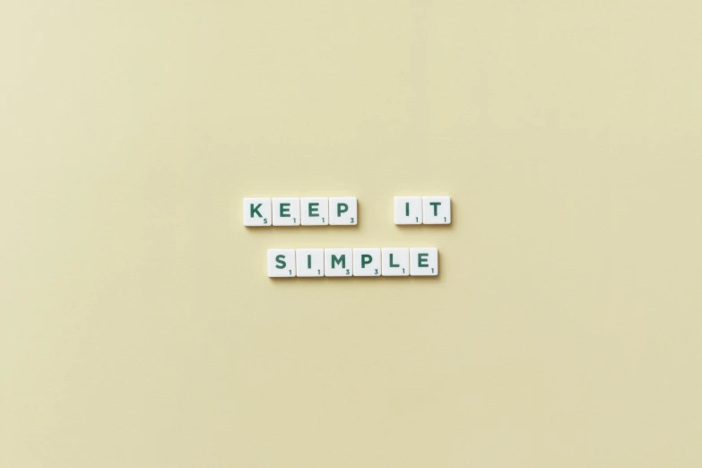 the words keep it simple spelled in scrabbles, a minimalist painting, pexels, tileable, simple form, tiny, bob