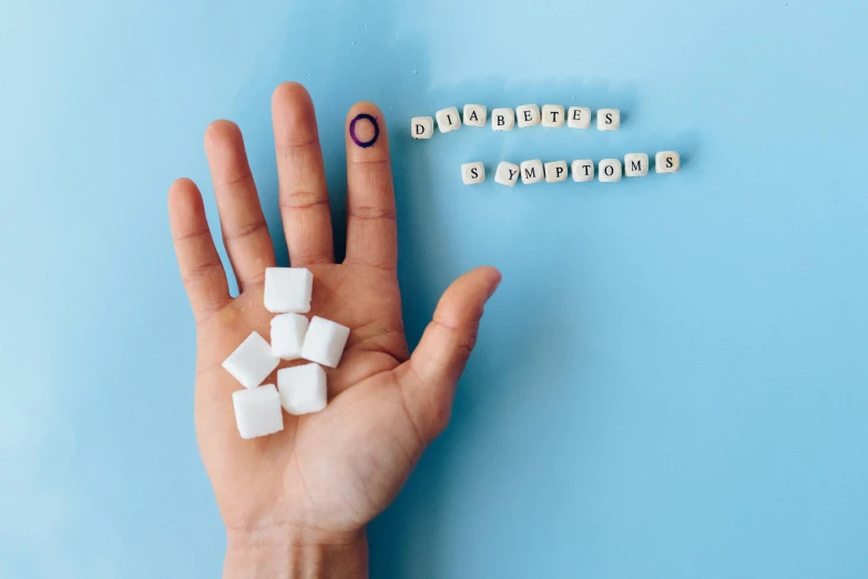 a person holding cubes of sugar in their hand, an album cover, by Arabella Rankin, trending on pexels, antipodeans, marfan syndrome, blue and white, background image, a portrait of @hypnos_onc
