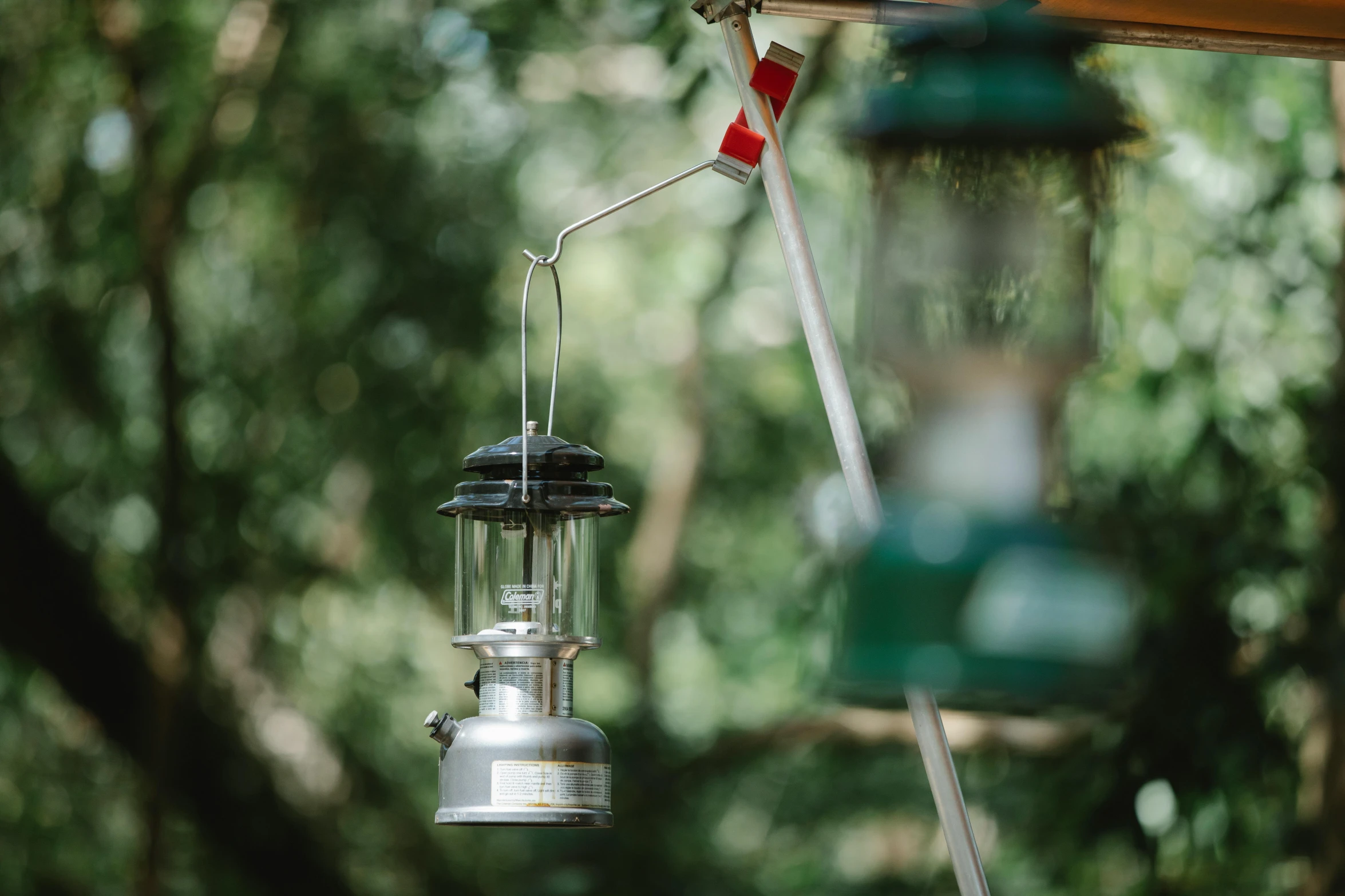 a lantern hanging from the side of a wooden structure, by Julian Allen, unsplash, carbide lamp, glamping, detail shot, low colour