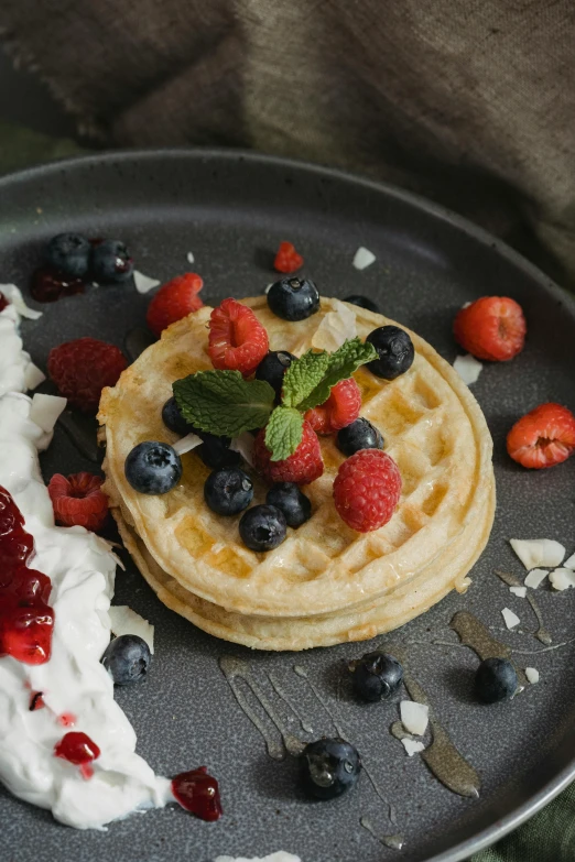 a plate of waffles topped with berries and whipped cream, a still life, by Matthias Stom, unsplash, background image, malaysian, navy, 15081959 21121991 01012000 4k