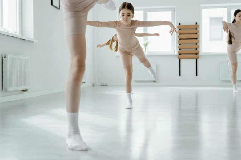 a group of young ballerinas in a dance studio, pexels contest winner, arabesque, medium shot of two characters, knobbly knees, thumbnail, low quality photo