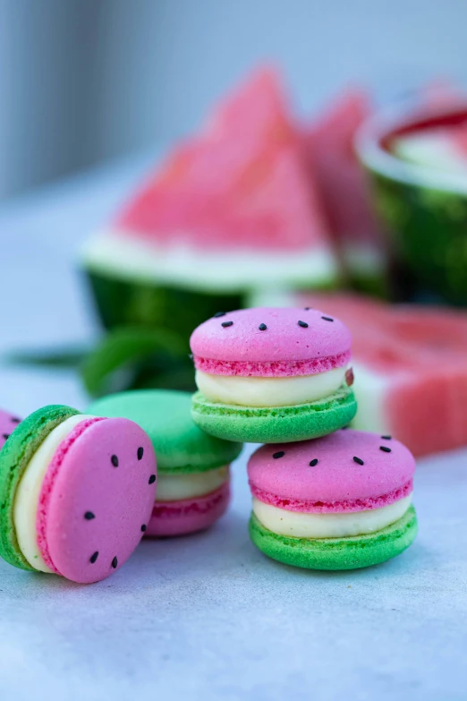 a pile of watermelon macarons sitting on top of a table, 3 colours, al fresco, watermelons, marshmallows