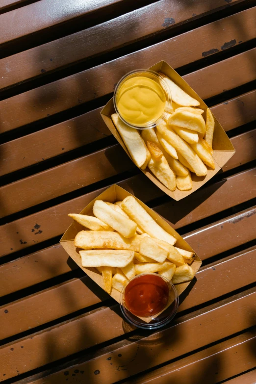 two trays of french fries with ketchup and mustard, inspired by Pia Fries, unsplash, dau-al-set, portrait photo, metallic, hut, 2070