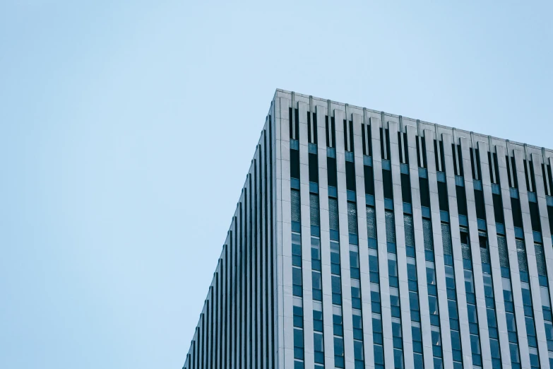 a plane flying in front of a tall building, a picture, unsplash, brutalism, square lines, blue gray, low detail, 1 2 9 7