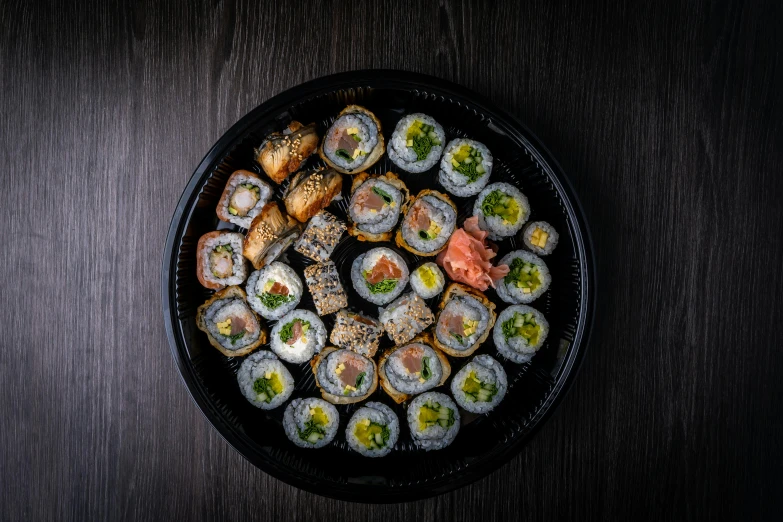 a plate of sushi on a wooden table, taken with sony alpha 9, grey, everything enclosed in a circle, premium