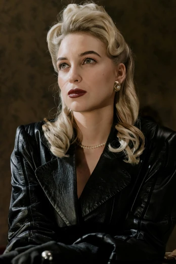 a woman in a black leather jacket sitting on a chair, a portrait, inspired by Evaline Ness, trending on pexels, photorealism, dressed like in the 1940s, margot robbie, sci - fi jewellery, cinematic outfit photo