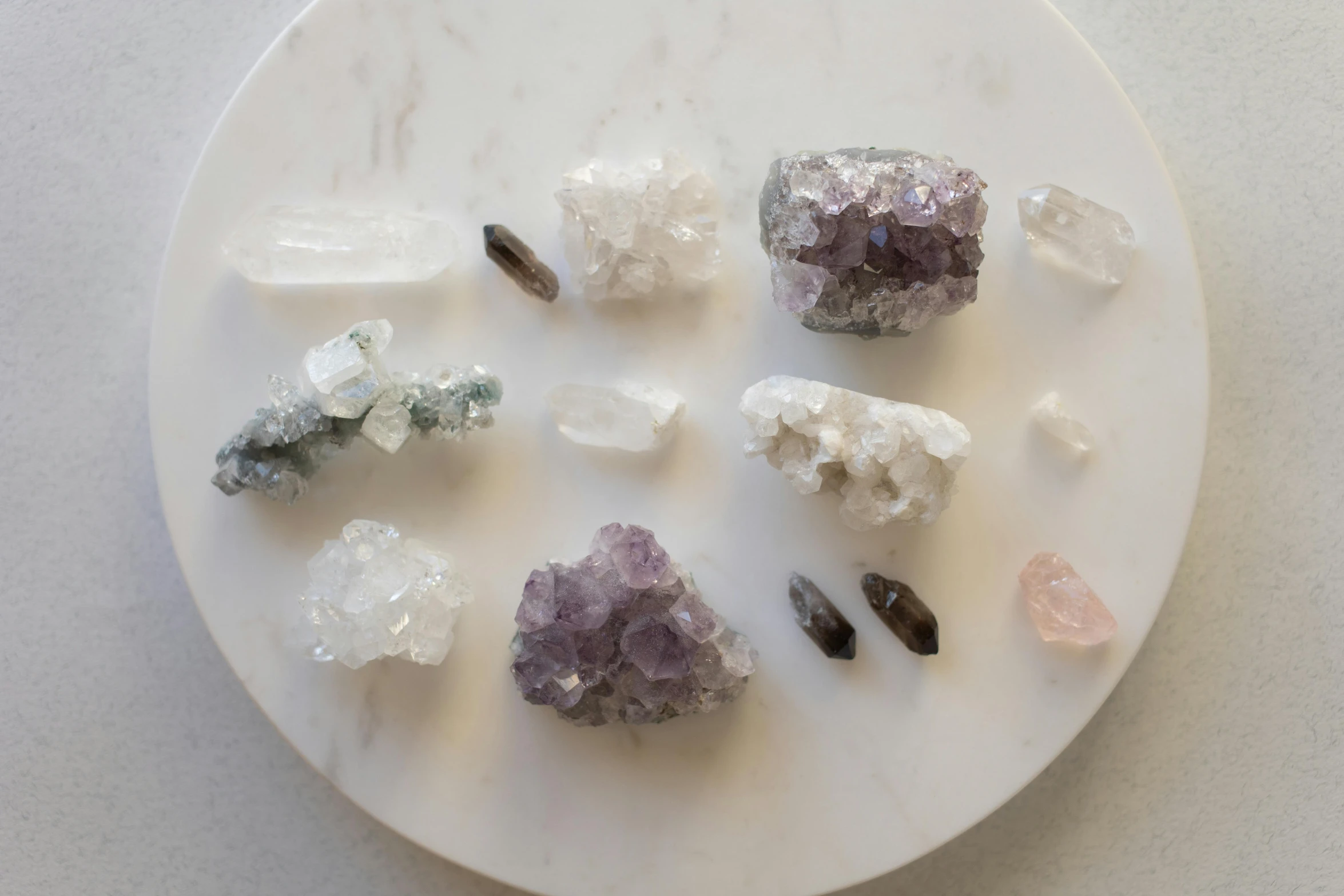 a white plate topped with different types of crystals, a marble sculpture, by Winona Nelson, trending on unsplash, quartz, white and purple, various posed, ash thorp