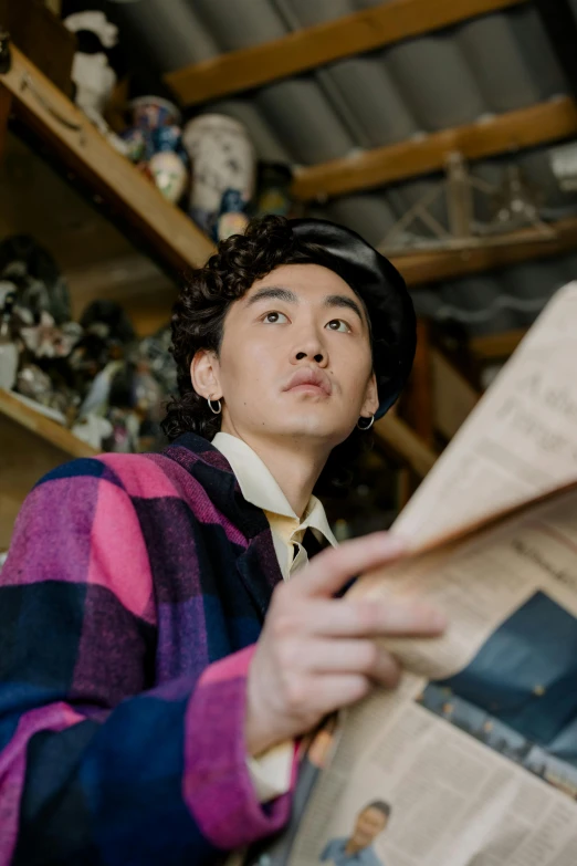 a man reading a newspaper in a room, an album cover, inspired by Hirohiko Araki, trending on pexels, robert sheehan, wearing correct era clothes, hong june hyung, portrait photo