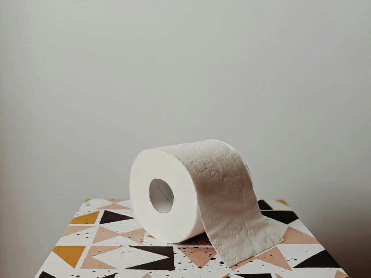 a roll of toilet paper sitting on top of a box, by Lucia Peka, unsplash, patterned, white table, muscle tissue, gif