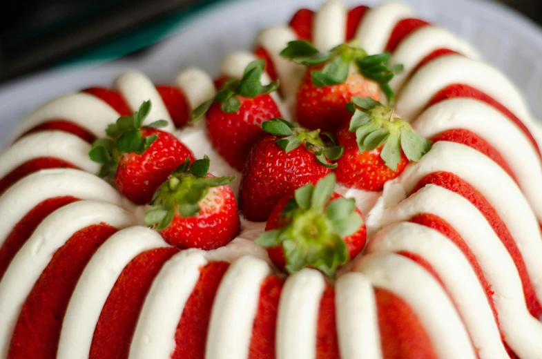 a red and white striped cake with strawberries on top, by Emma Andijewska, unsplash, smooth curvilinear design, full frame image, jelly, gelatinous symmetrical