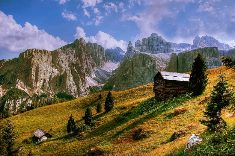 a small cabin on a grassy hill with mountains in the background, a matte painting, by Karl Gerstner, pexels contest winner, renaissance, dolomites, 2 0 0 0's photo, panoramic, colorful scene