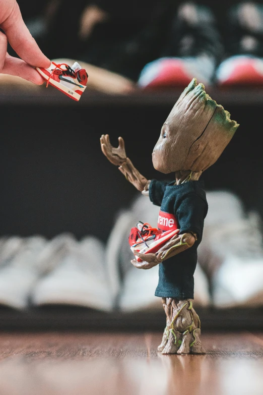 a close up of a figurine of a baby grooter, unsplash, basketball sneaker concept art, groot, presenting wares, streetwear