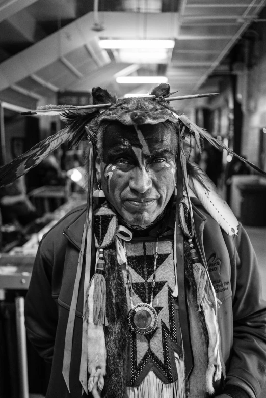 a black and white photo of a native american man, pexels contest winner, process art, west world show, in a workshop, shamans and strange creatures, great red feather